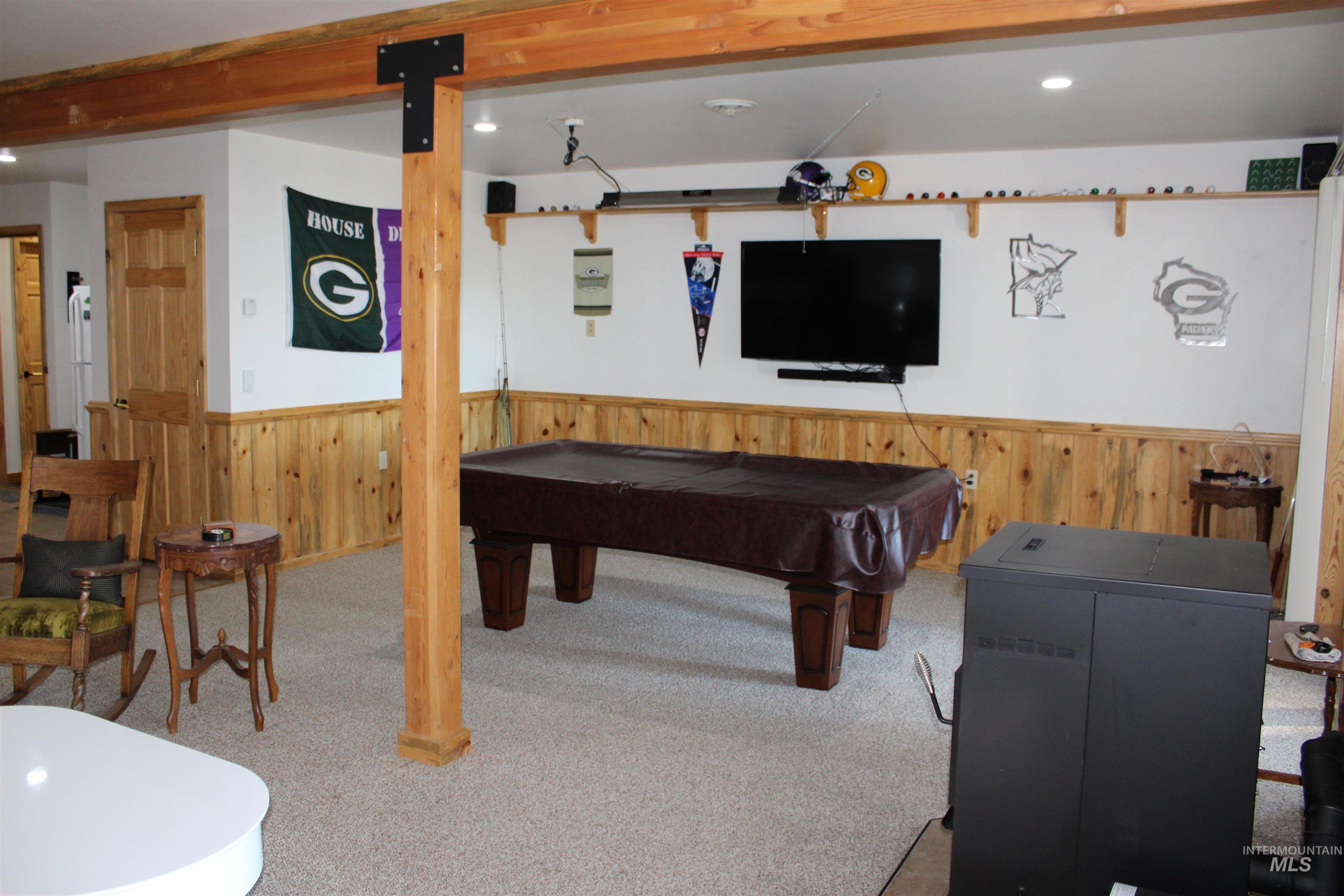 31 Rainbow Ridge Road Garden Valley, ID 83622 - Photo 21 of 33 Walk out basement with a wainscoted wall, wood walls, billiards, carpet flooring, and recessed lighting