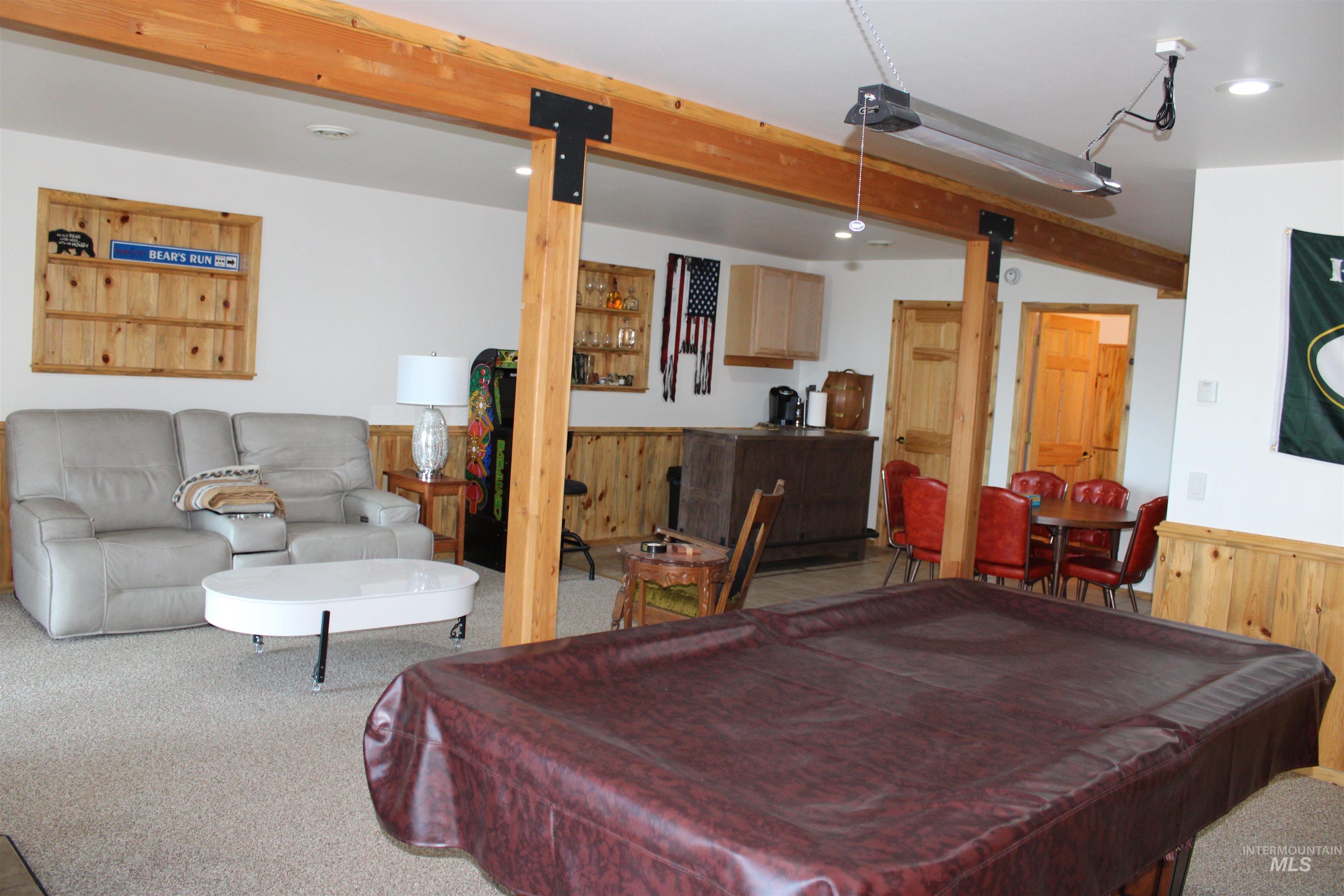 31 Rainbow Ridge Road Garden Valley, ID 83622 - Photo 22 of 33 Walk out basement featuring recessed lighting, wood walls, a wainscoted wall, carpet floors, and beam ceiling
