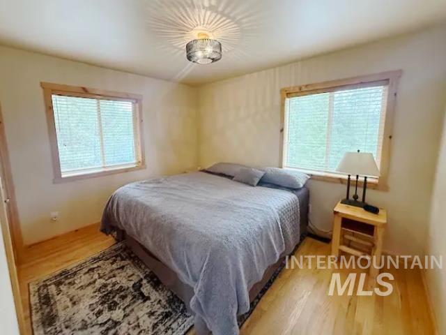 31 Rainbow Ridge Road Garden Valley, ID 83622 - Photo 6 of 33 Bedroom featuring light wood floors and multiple windows