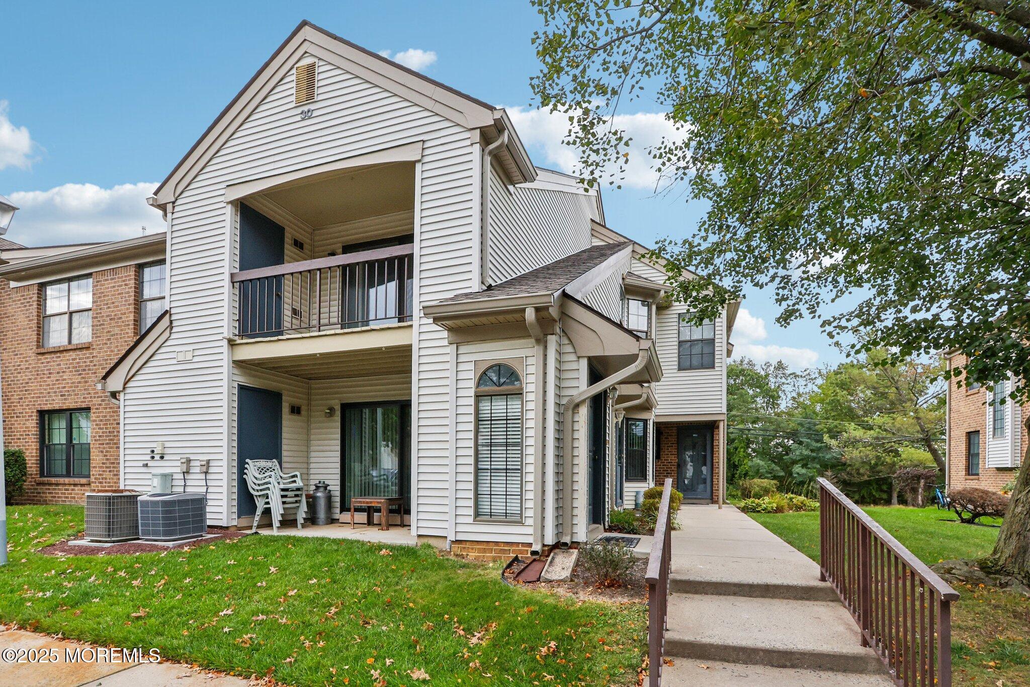 3015 Lighthouse Lane, Unit 3015 Parlin, NJ 08859 - Photo 1 of 22 front view of a house with a yard