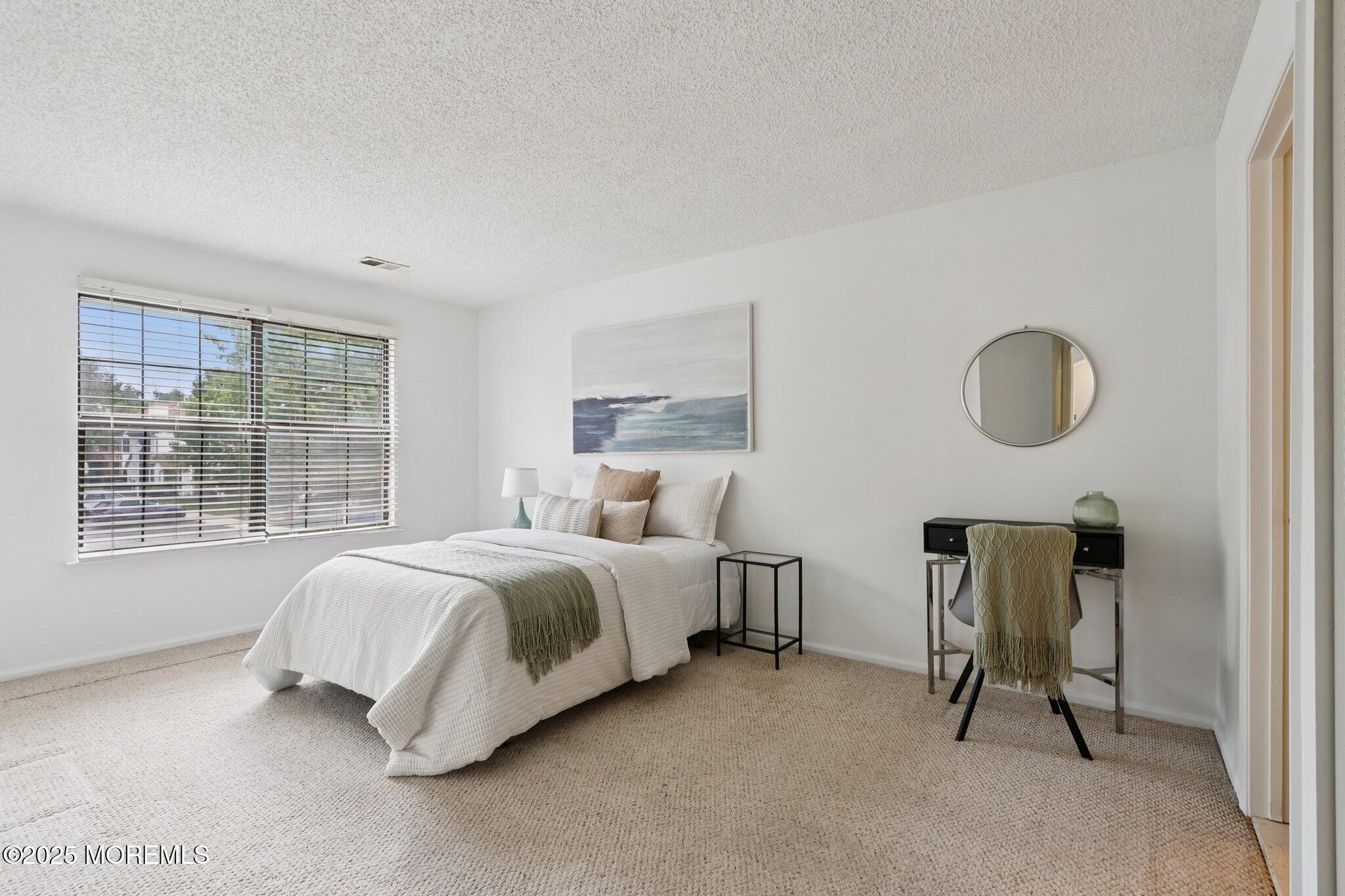 3015 Lighthouse Lane, Unit 3015 Parlin, NJ 08859 - Photo 15 of 22 a spacious bedroom with a bed and a window