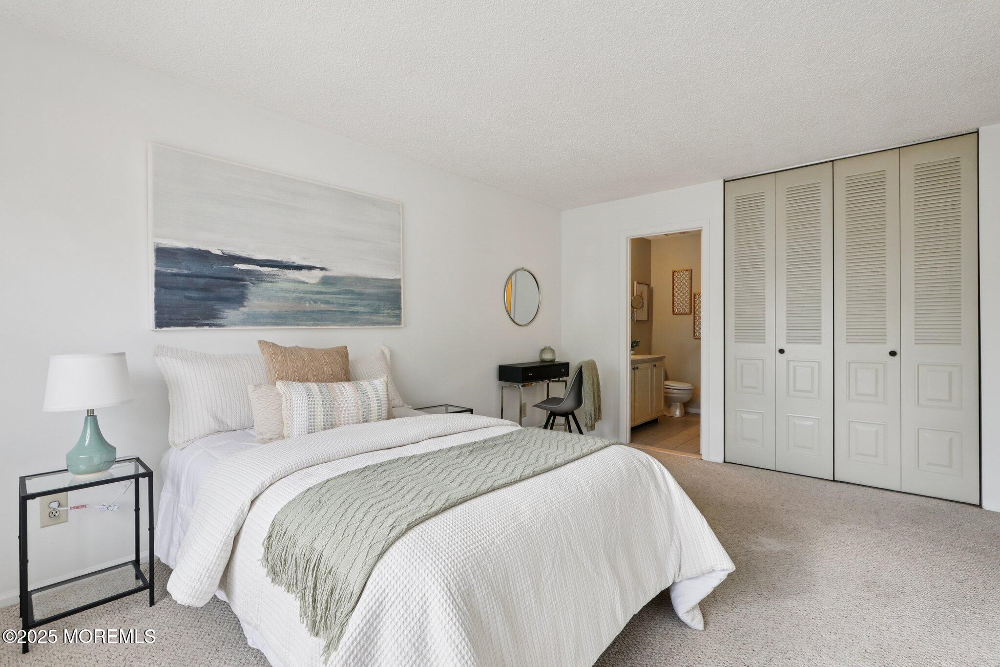 3015 Lighthouse Lane, Unit 3015 Parlin, NJ 08859 - Photo 16 of 22 a bed room with a bed and a lamp