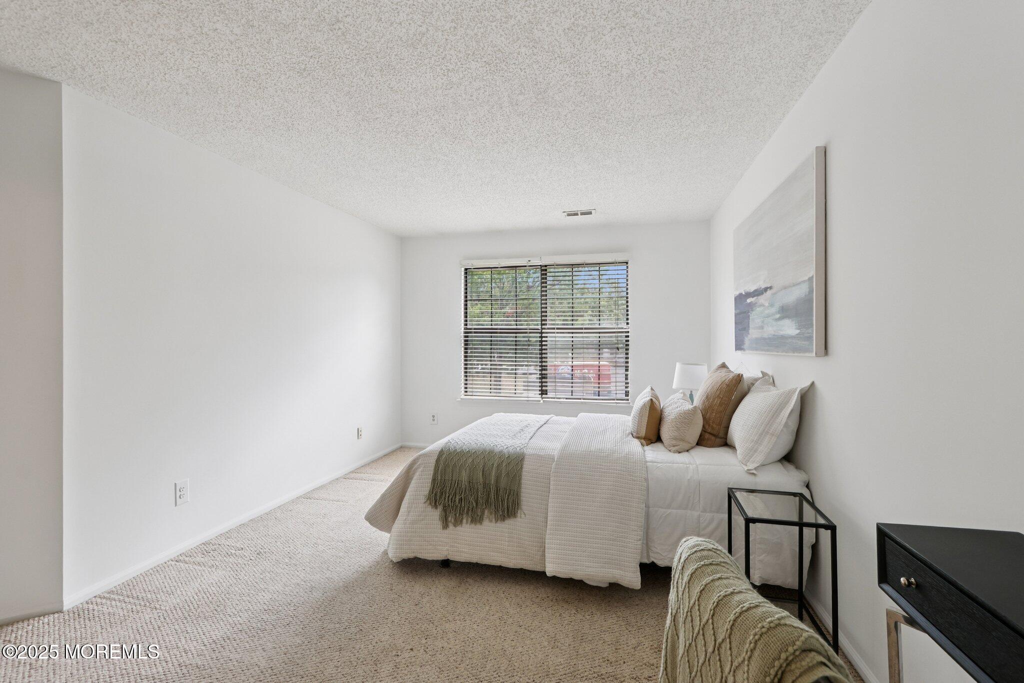 3015 Lighthouse Lane, Unit 3015 Parlin, NJ 08859 - Photo 17 of 22 a bedroom with a bed and a window