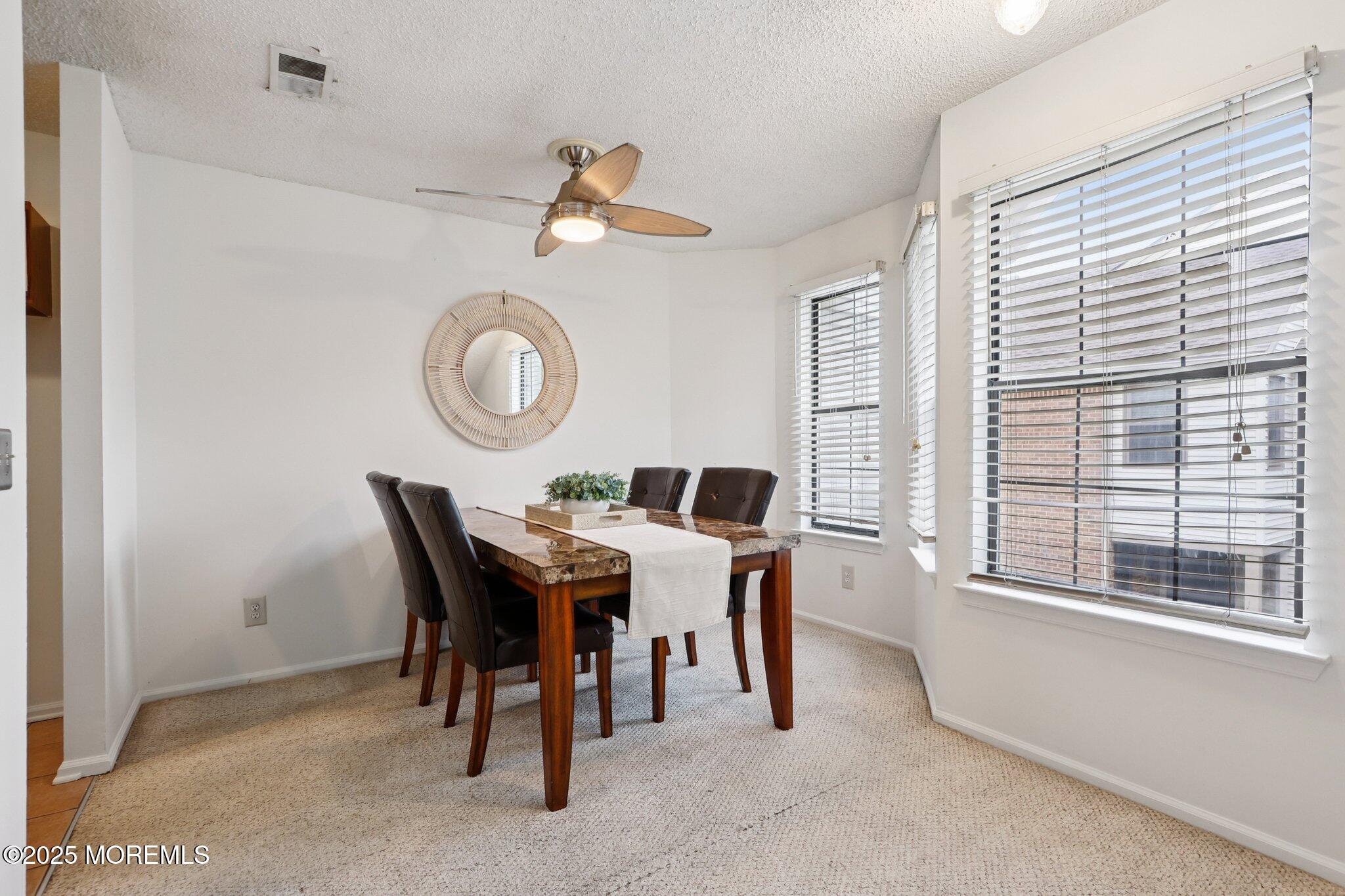 3015 Lighthouse Lane, Unit 3015 Parlin, NJ 08859 - Photo 9 of 22 a view of a dining room with furniture and a large window
