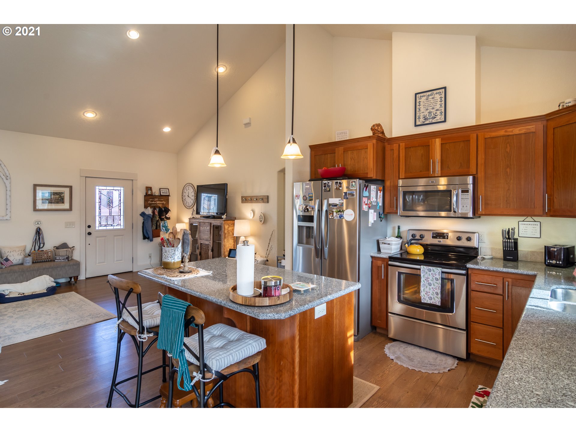463 South 47th Street Springfield, OR 97478 - Photo 7 of 25 a kitchen with stainless steel appliances granite countertop a stove refrigerator a sink dishwasher with a dining table and chairs