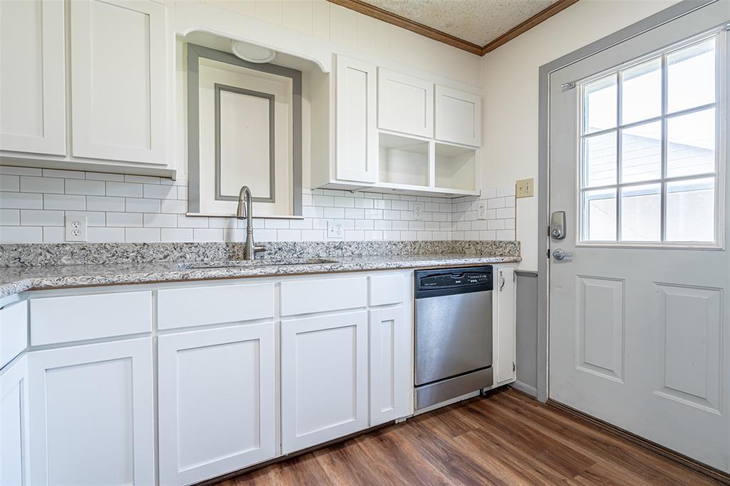 501 Endora Dublin, TX 76446 - Photo 15 of 39 a kitchen with granite countertop white cabinets and white appliances