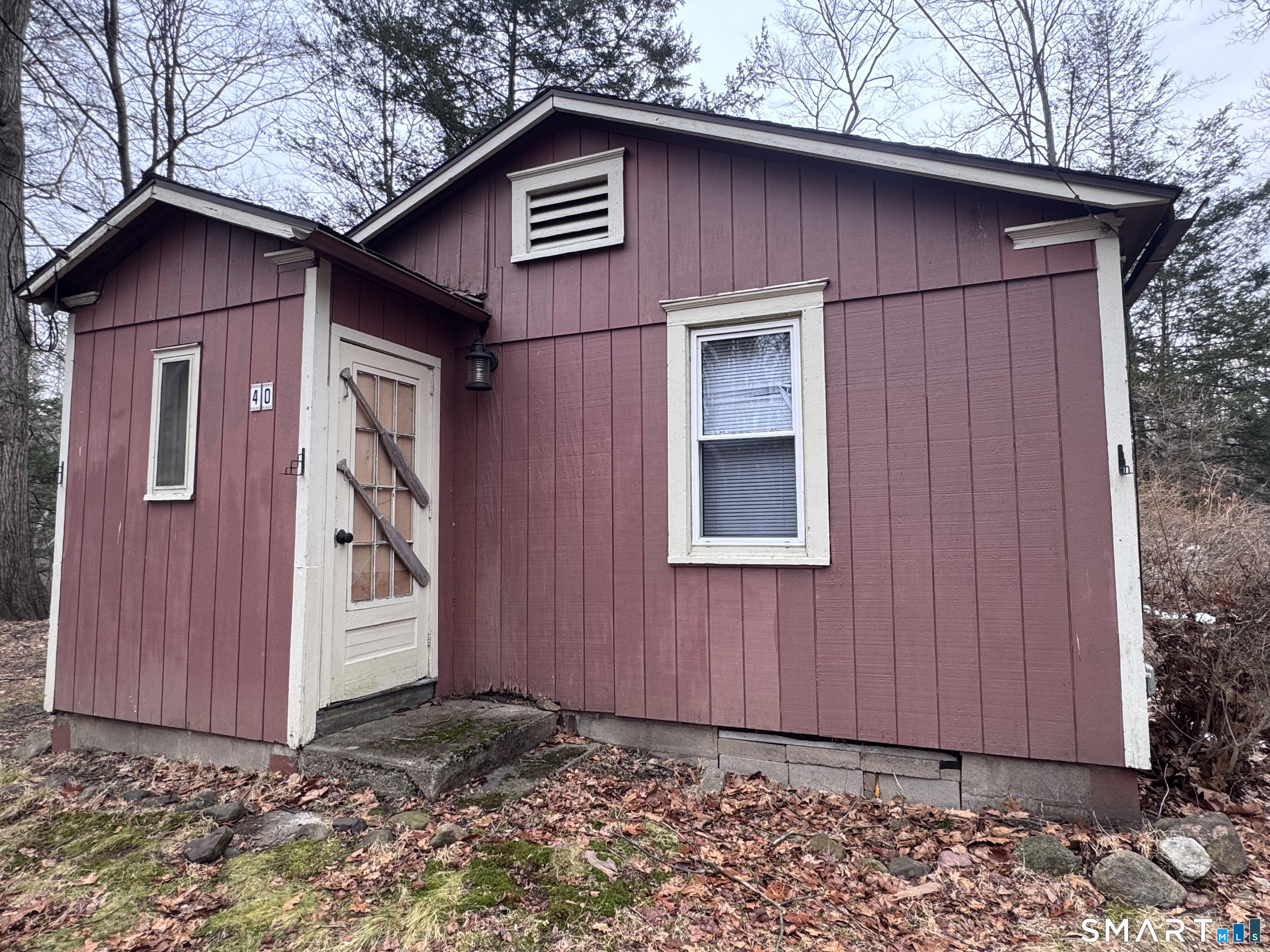40 Flood Bridge Road Southbury, CT 06488 - Photo 2 of 15 a view of a wooden house with a small yard and wooden fence