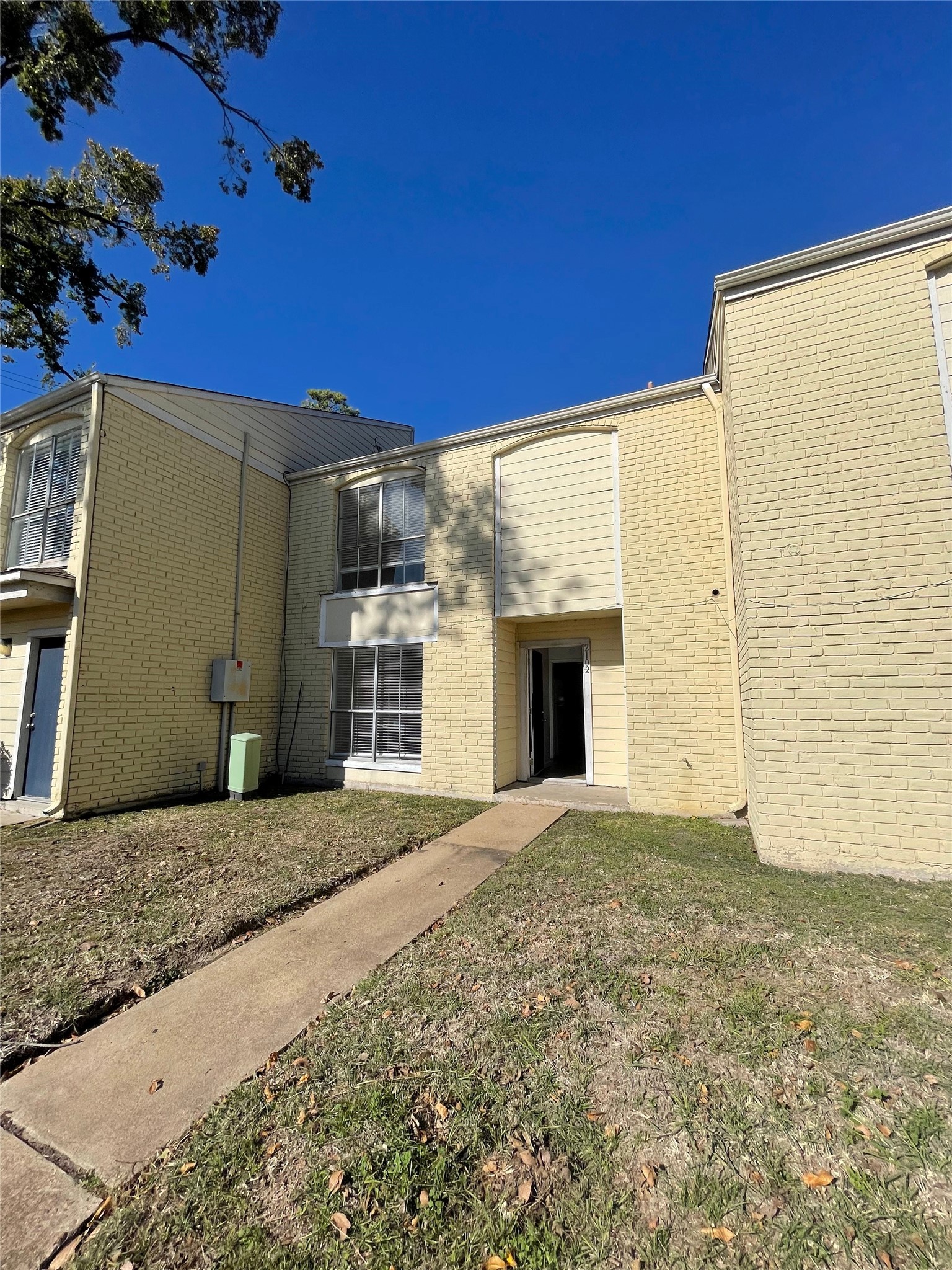 6200 West Tidwell Road, Unit 2102 Houston, TX 77092 - Photo 3 of 14 a view of a house with a yard