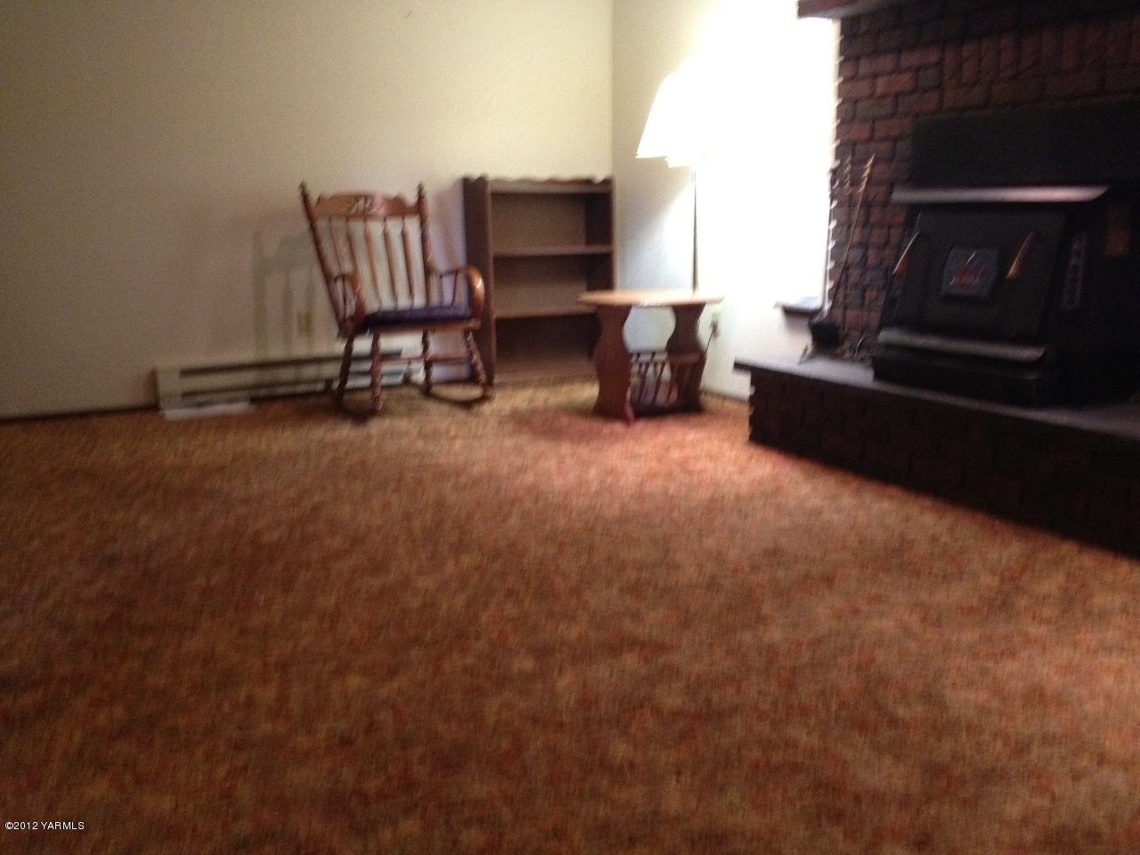 8004 Rutherford Road Yakima, WA 98903 - Photo 41 of 42 a living room with furniture a flat screen tv and a fireplace