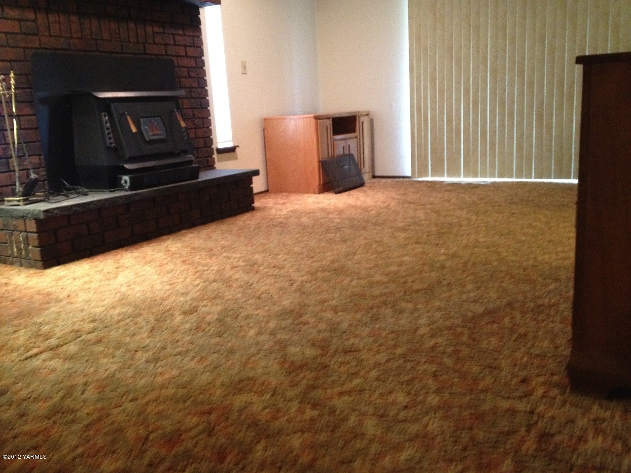 8004 Rutherford Road Yakima, WA 98903 - Photo 42 of 42 a view of an empty room with a fireplace and a microwave