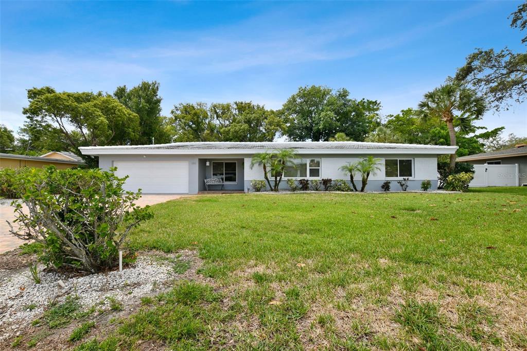 a front view of house with a garden