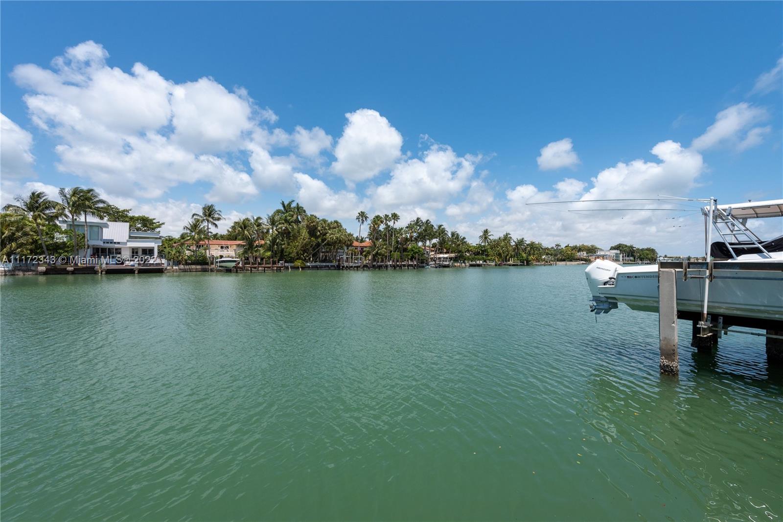 6350 Allison Road Miami Beach, FL 33141 - Photo 2 of 3 a view of a lake with table and chairs