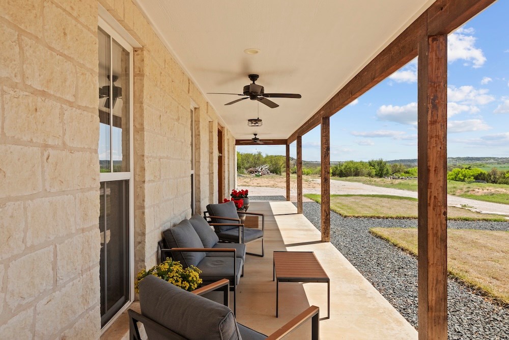 792 Langes Mill Road Doss, TX 78618 - Photo 13 of 76 a living room with furniture and floor to ceiling windows