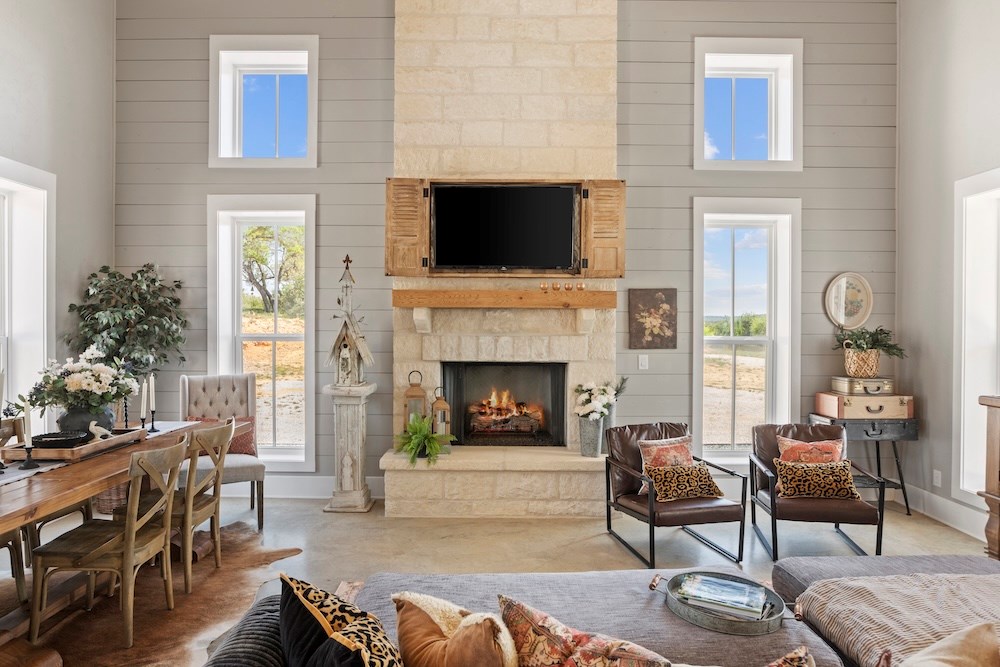 792 Langes Mill Road Doss, TX 78618 - Photo 18 of 76 a living room with furniture a flat screen tv and a fireplace