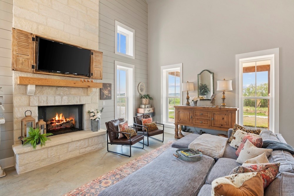 792 Langes Mill Road Doss, TX 78618 - Photo 20 of 76 a living room with furniture a fireplace and a flat screen tv