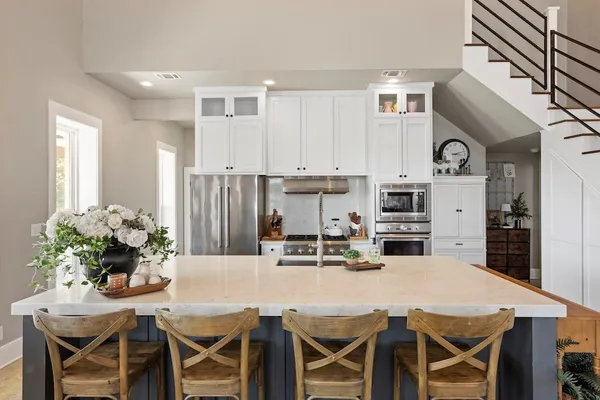 a living room with furniture and a potted plant