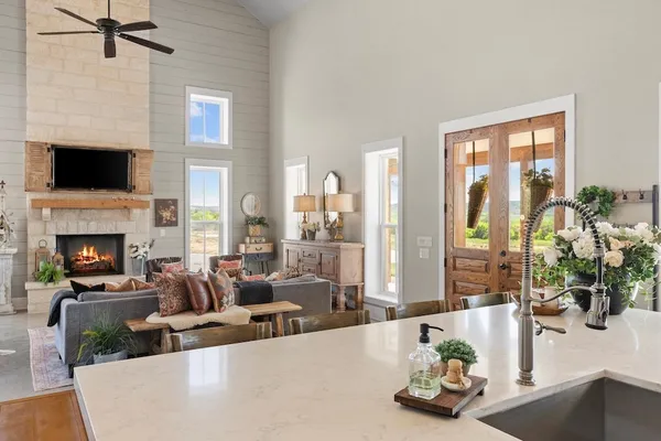 a bathroom with a sink a potted plant and a shower