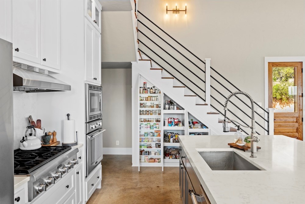 792 Langes Mill Road Doss, TX 78618 - Photo 32 of 76 a kitchen with stainless steel appliances kitchen island granite countertop a sink and a stove