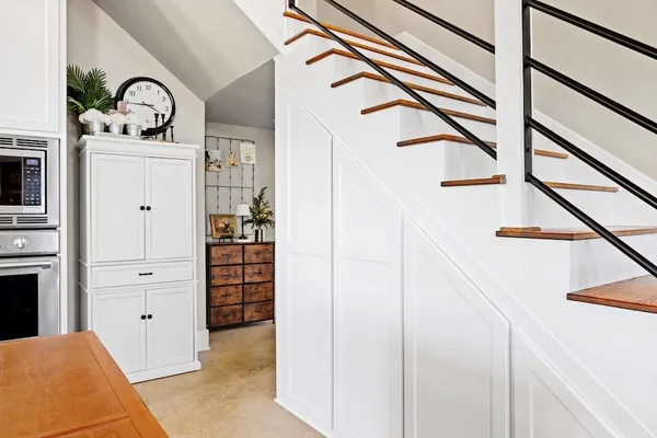 a view of a hallway with wooden floor