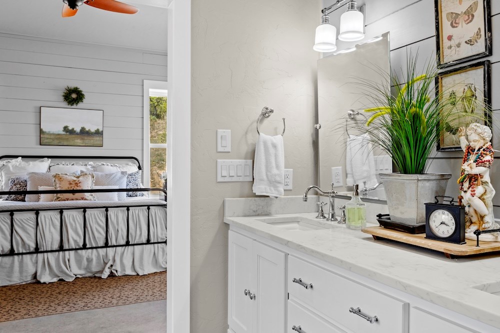 792 Langes Mill Road Doss, TX 78618 - Photo 40 of 76 a bathroom with a double vanity sink and a mirror