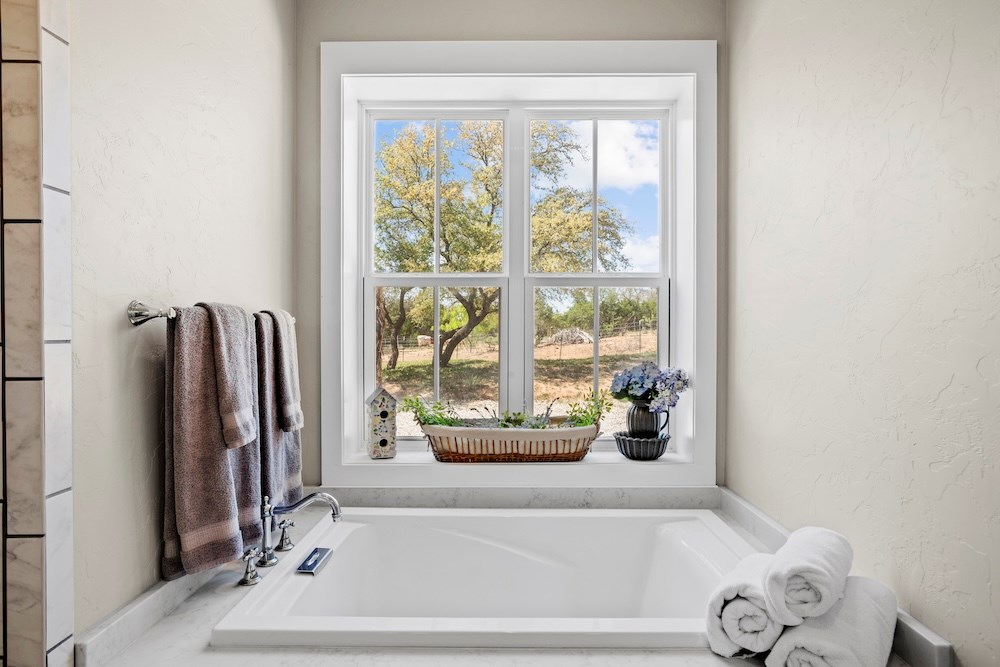 792 Langes Mill Road Doss, TX 78618 - Photo 44 of 76 a bathroom with a tub and a shower