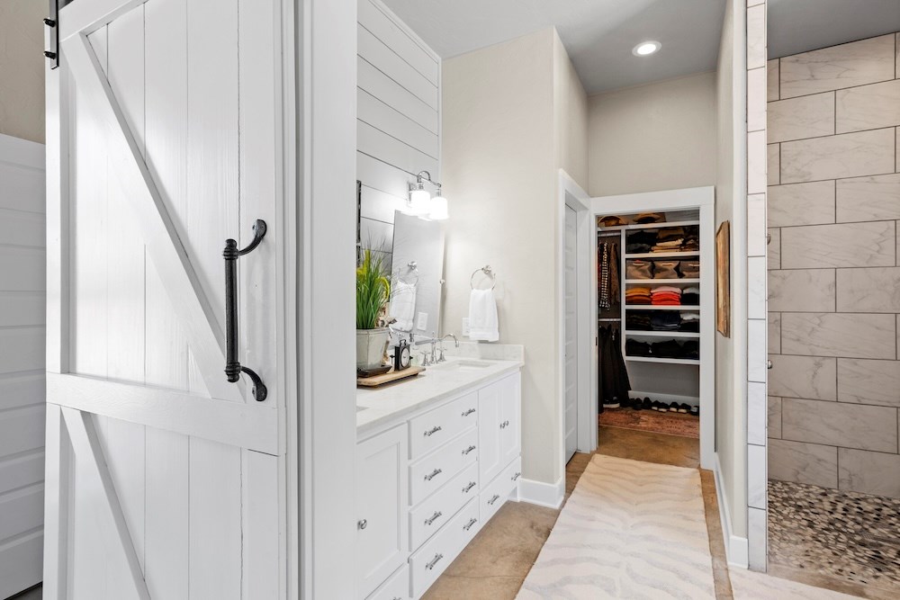 792 Langes Mill Road Doss, TX 78618 - Photo 45 of 76 a bathroom with a double vanity sink and a mirror