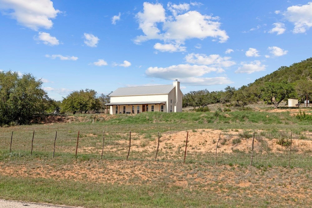 792 Langes Mill Road Doss, TX 78618 - Photo 5 of 76 a view of a lake with a building in the background