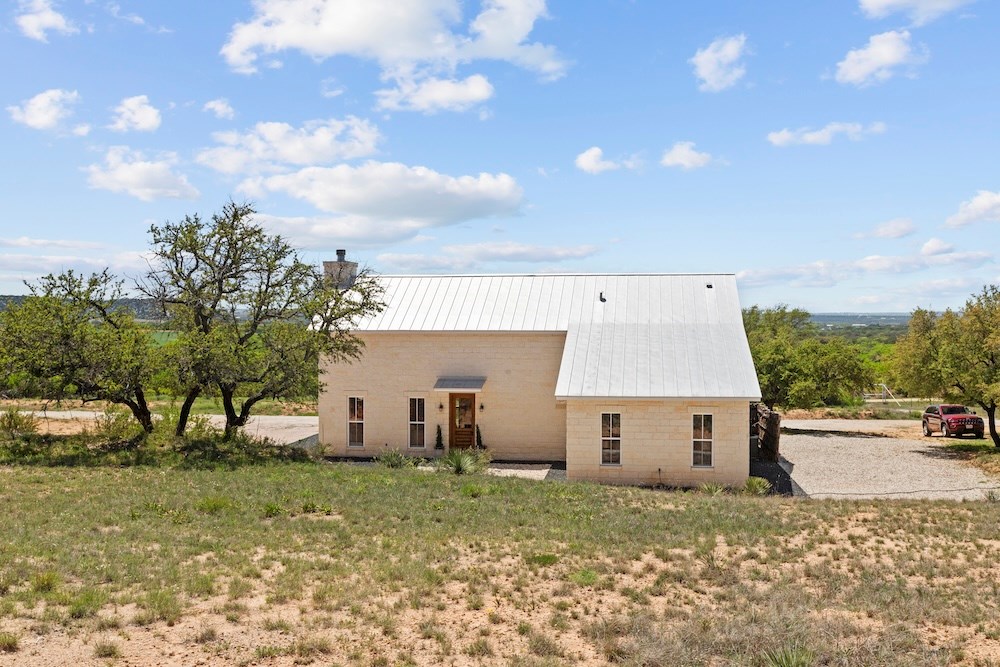792 Langes Mill Road Doss, TX 78618 - Photo 63 of 76 a view of a house with a back yard