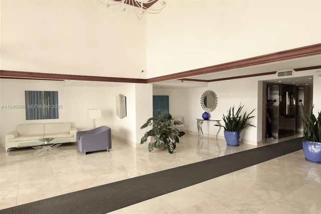 a view of living room with furniture and potted plant