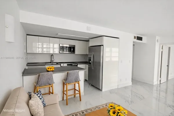a kitchen with stainless steel appliances a refrigerator and a stove top oven