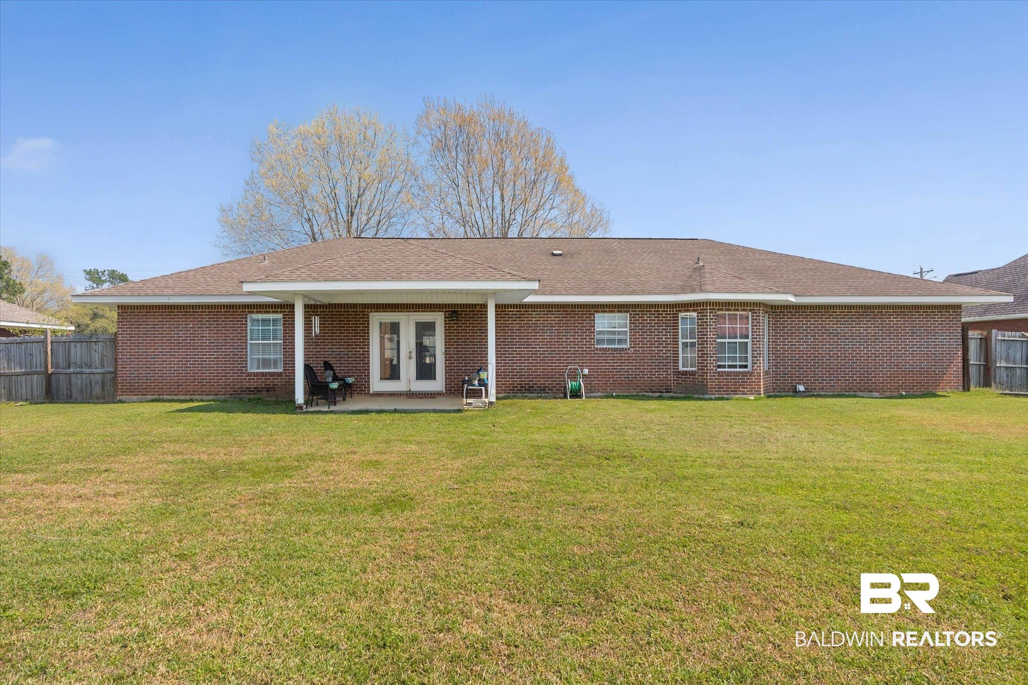 22095 Buck Road Robertsdale, AL 36567 - Photo 20 of 22 Back of property with a patio, brick siding, french doors, and a shingled roof