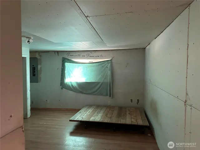 a room with wooden floor and pool table