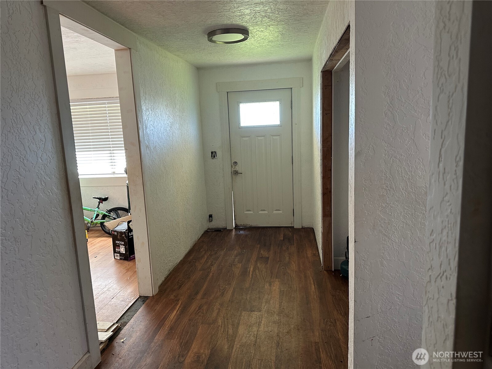 206 West Cushing Street Aberdeen, WA 98520 - Photo 6 of 25 a view of a hallway with wooden floor and stairs