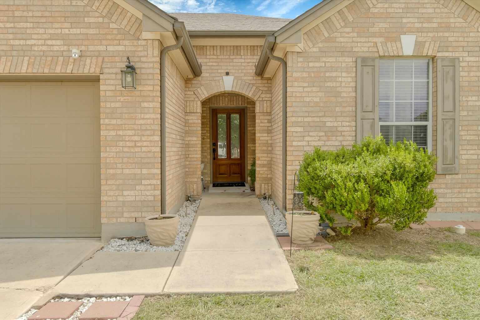 460 Waterleaf Boulevard Kyle, TX 78640 - Photo 4 of 30 A classic brick exterior offers enduring appeal with a welcoming front entry.