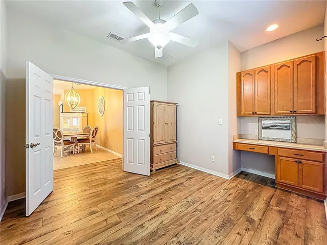 a view of a kitchen with wooden floor and a sink