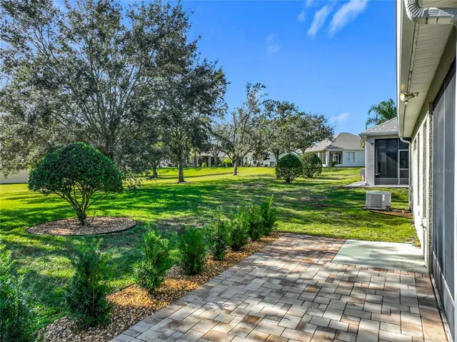 an aerial view of a house with a yard and trees
