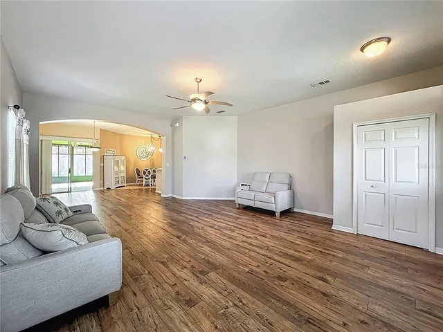 a living room with furniture and a chandelier
