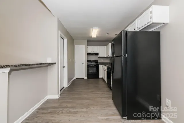 a kitchen with stainless steel appliances granite countertop a refrigerator and a stove