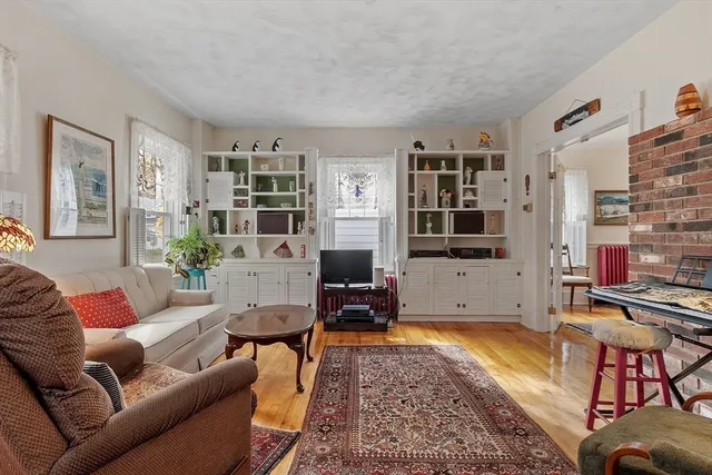 a living room with furniture a flat screen tv and a table