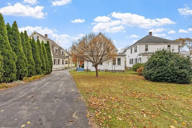 a yellow house with trees in front of it