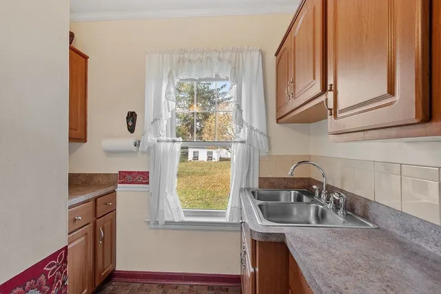 a kitchen with stainless steel appliances granite countertop a sink and a window