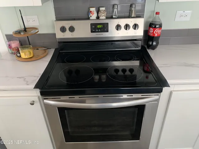 a stove top oven sitting inside of a kitchen