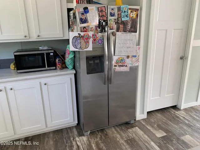 a kitchen with stainless steel appliances granite countertop a refrigerator and a stove
