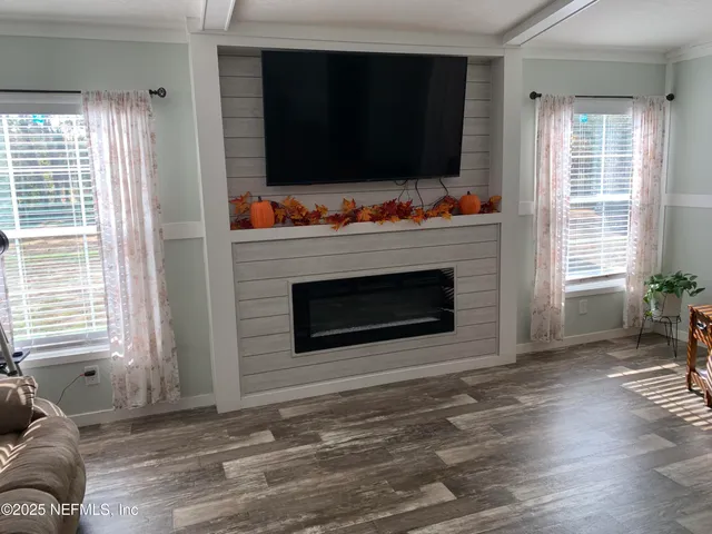 a living room with furniture flat screen tv and a fireplace