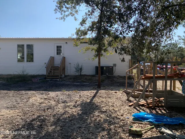 a view of a house with yard and sitting area