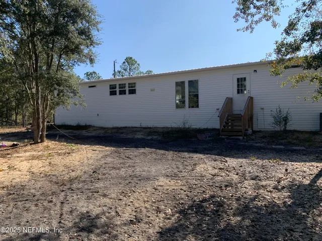 a view of a back yard of the house