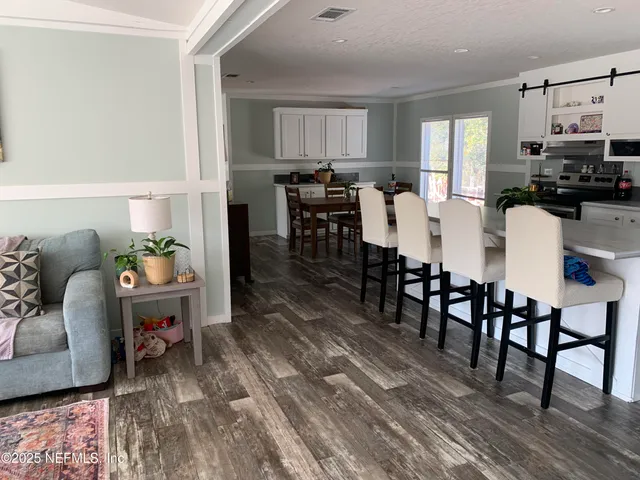 a view of kitchen with dining table and chairs