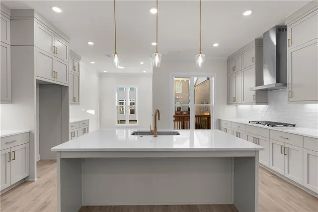 a kitchen with a sink a stove a refrigerator and white cabinets