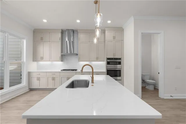 a bathroom with a sink a vanity a large mirror and shower