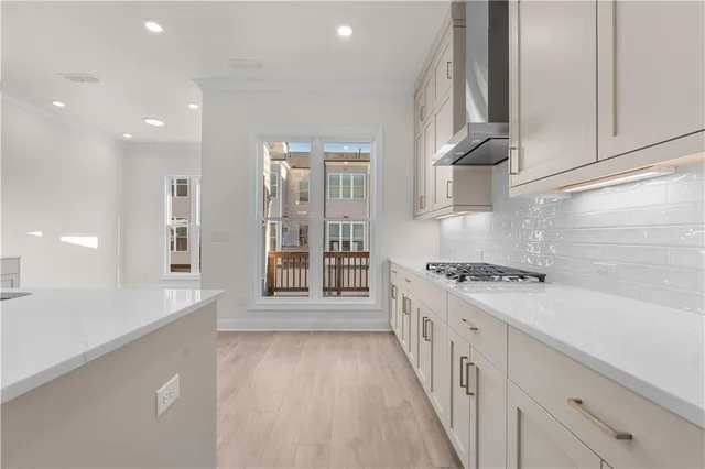 a kitchen with kitchen island a sink stainless steel appliances and cabinets